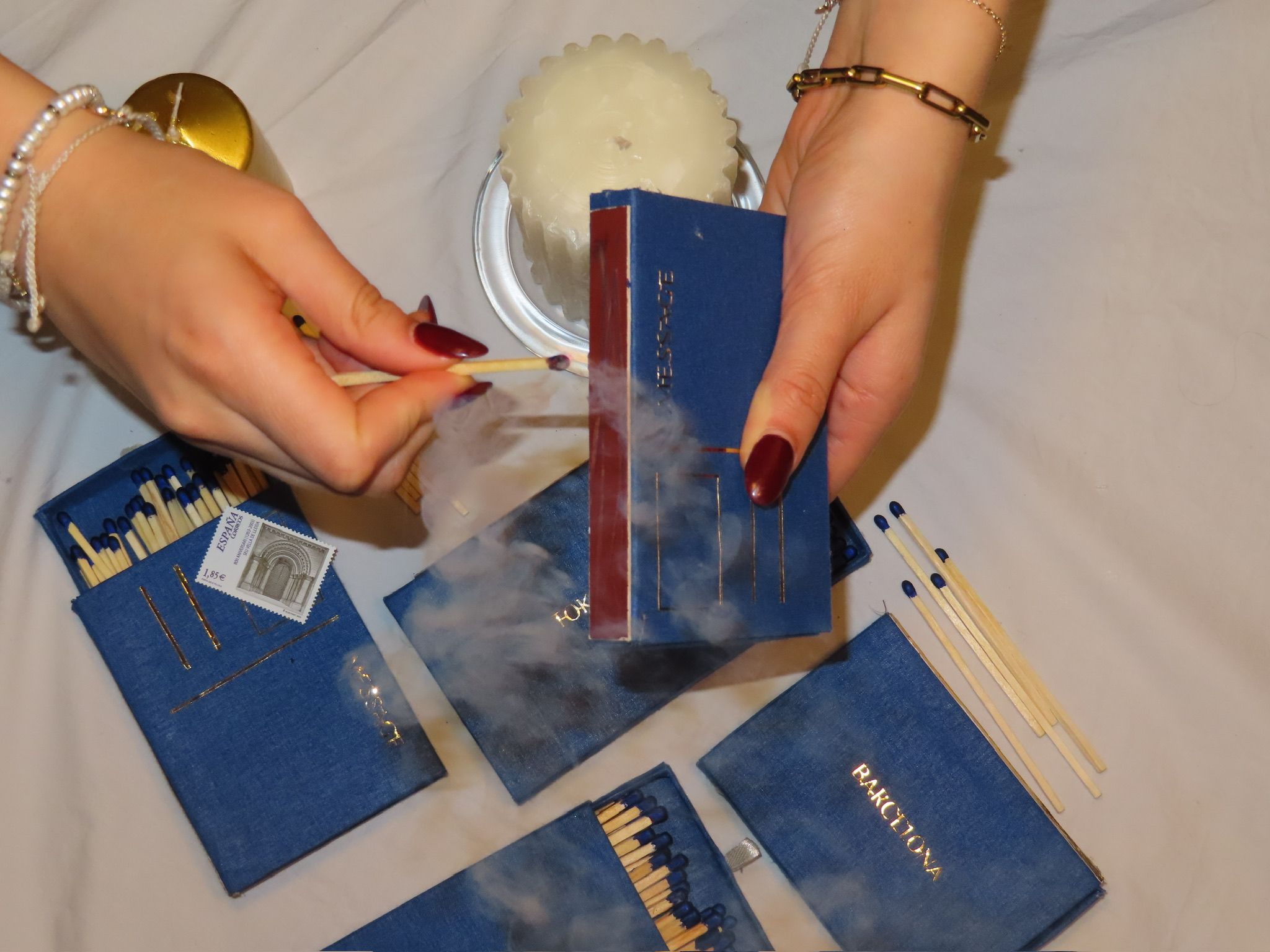 matches lying on top of eachother with a person stricking a match